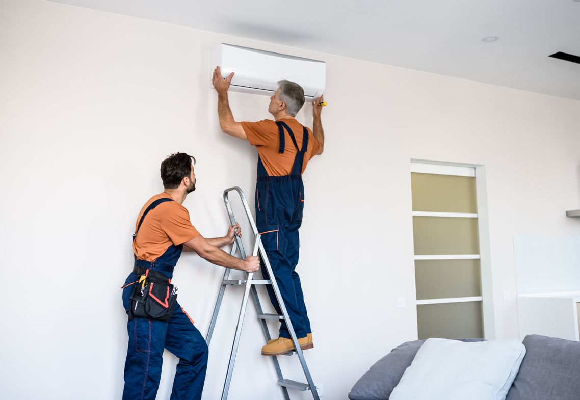 two men installing air conditioning